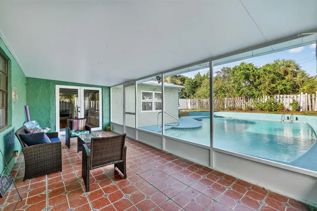 a living room filled with furniture and a floor to ceiling window