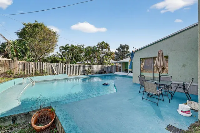 a backyard of a house with table and chairs