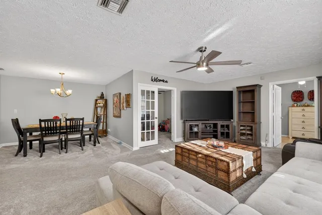 a bedroom with furniture and a flat screen tv