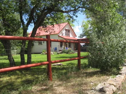 a view of a house with a yard table and chairs