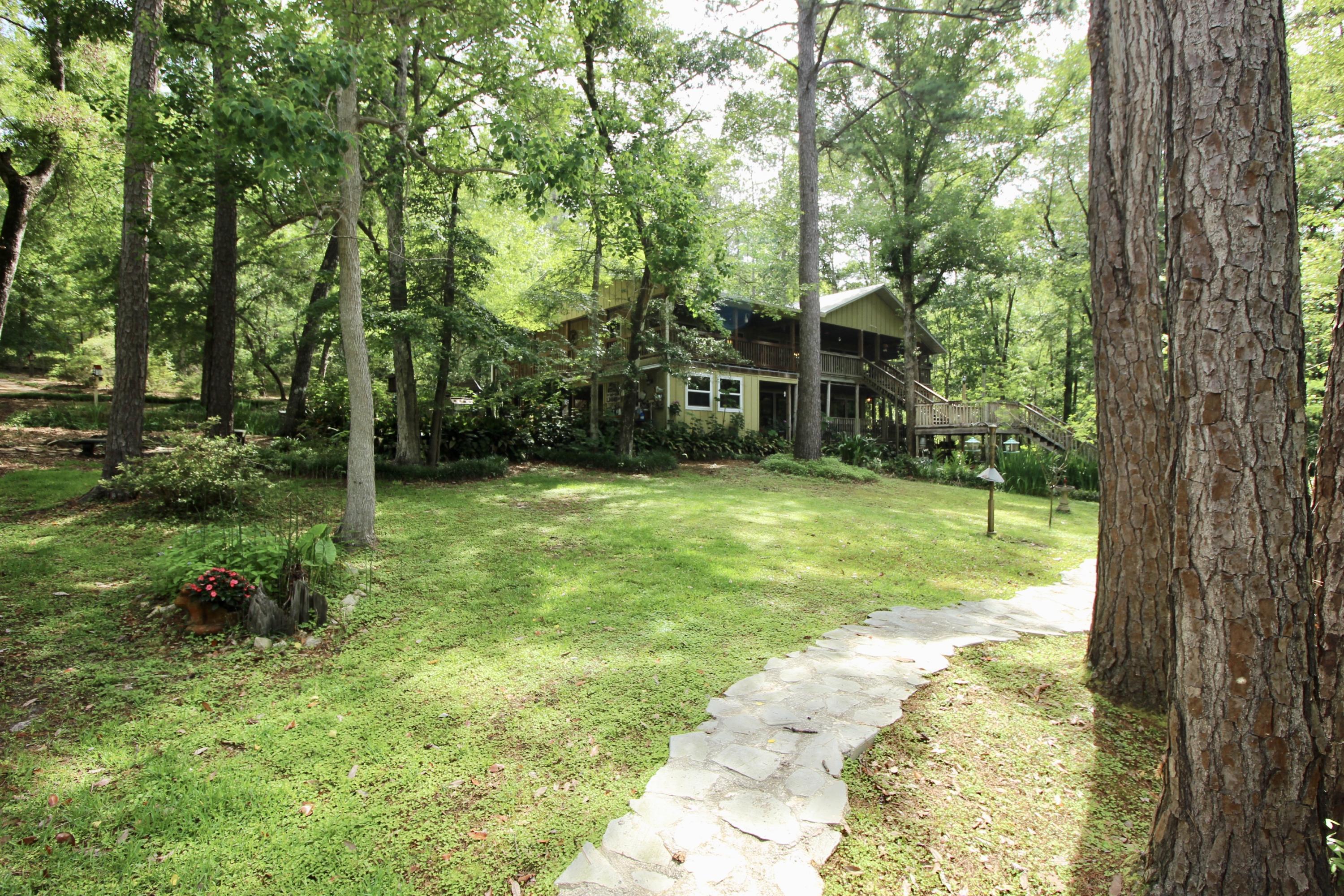 180 Tim Boland Road DeFuniak Springs, FL 32435 - Photo 54 of 85 a view of a house with a big yard and large trees