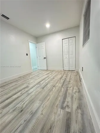 a view of room with wooden floor