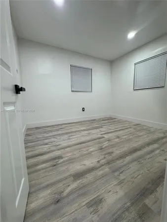 a view of room with window and hardwood floor