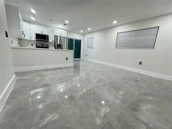 a view of a kitchen with microwave and cabinets