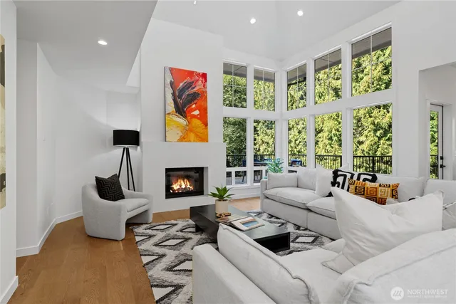 a living room with furniture fireplace and a large window