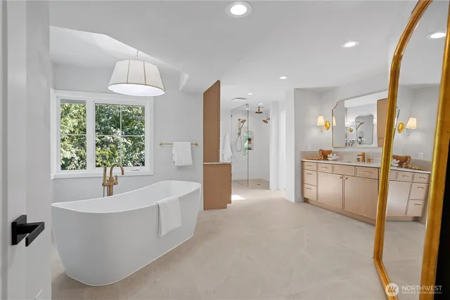 a bathroom with a tub sink and mirror