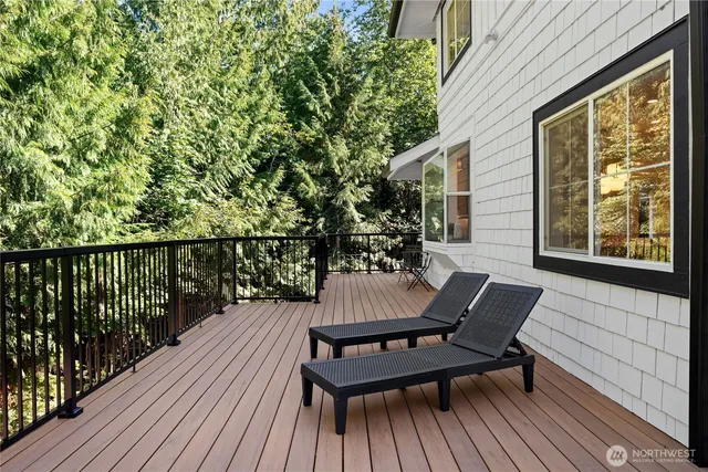 a view of a wooden chairs on the roof deck