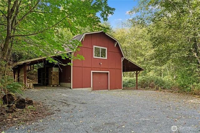 a view of a house with a yard and large tree