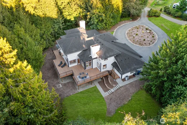 an aerial view of a house with garden space and trees