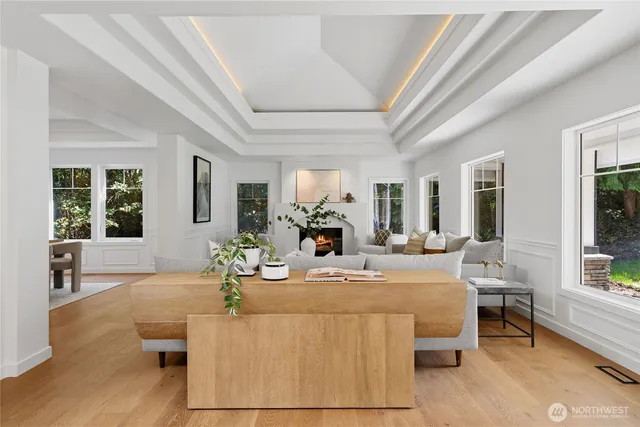 a living room with furniture a large window and potted plants