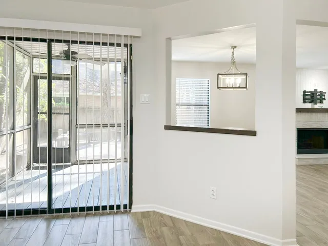 a view of wooden floor and a window in a room