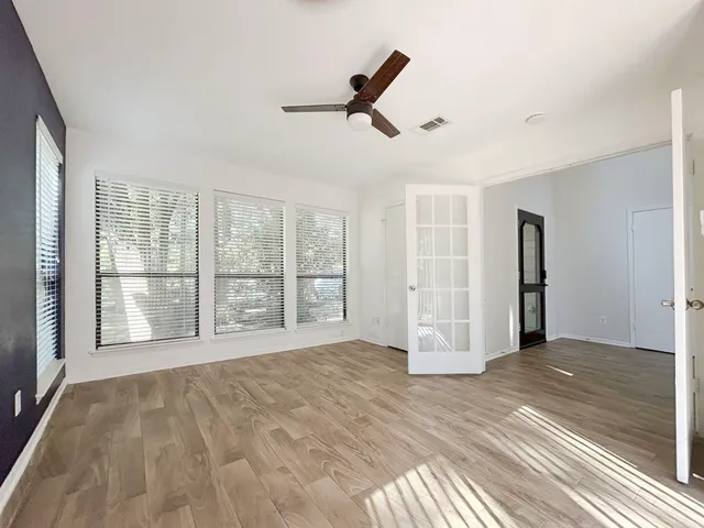 a backyard of a house with table and chairs