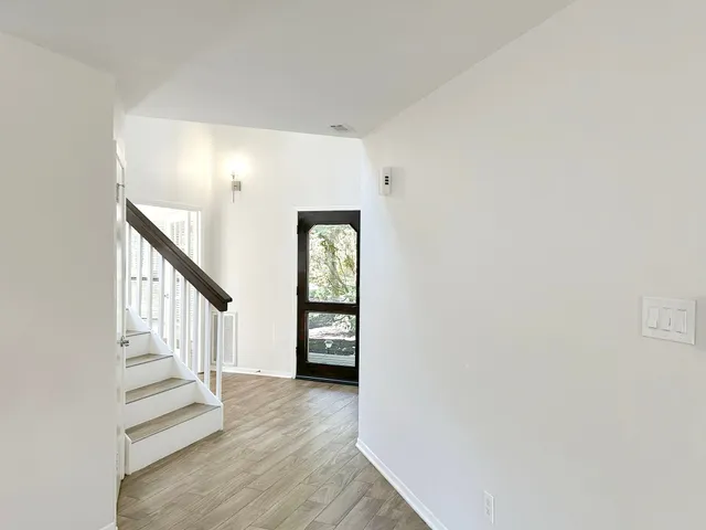 a view of an entryway with wooden floor