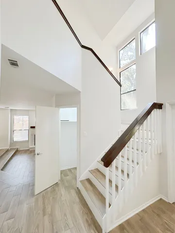 a view of entryway and hall with wooden floor
