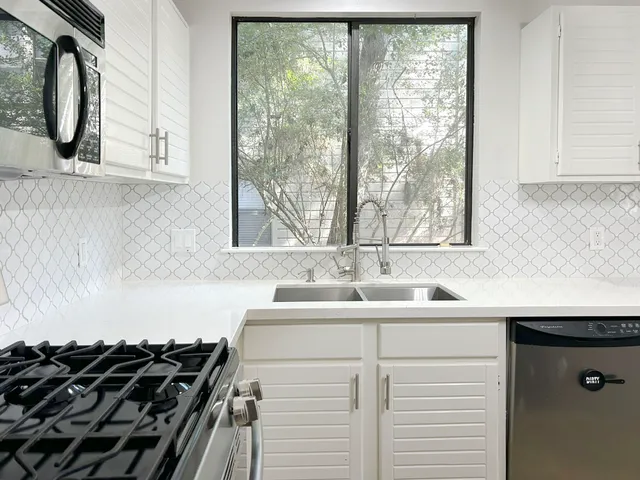 a kitchen with a sink and a window