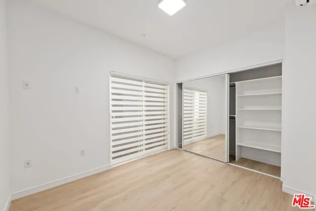 a view of an empty room with a closet