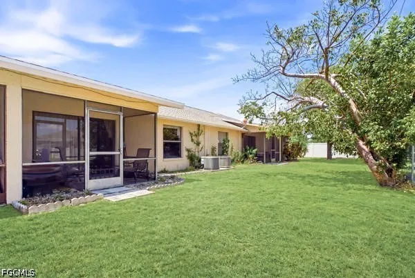 a view of a house with backyard porch and garden