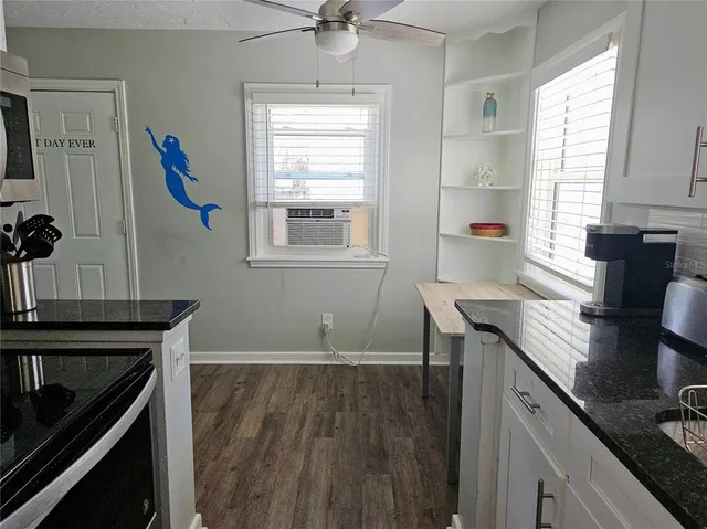 a bedroom with a bed and a dresser next to a window