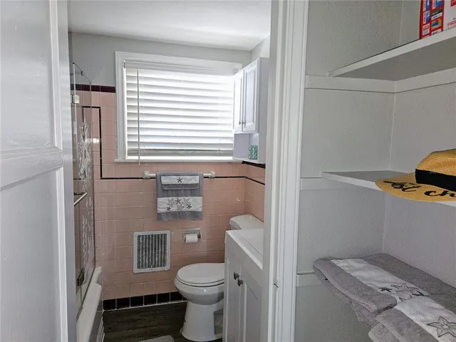 a bathroom with a shower a toilet and a sink