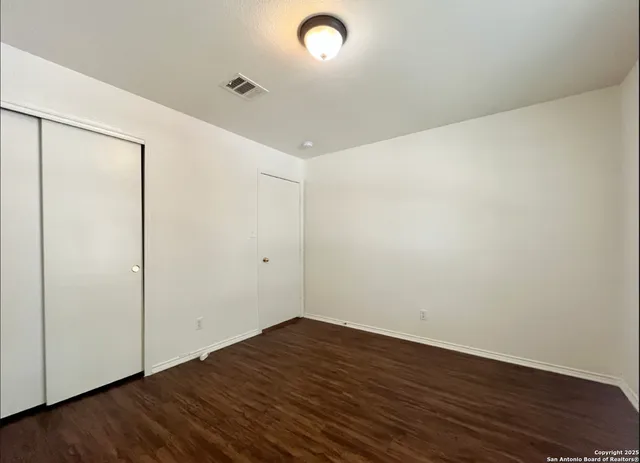 a view of a room with wooden floor