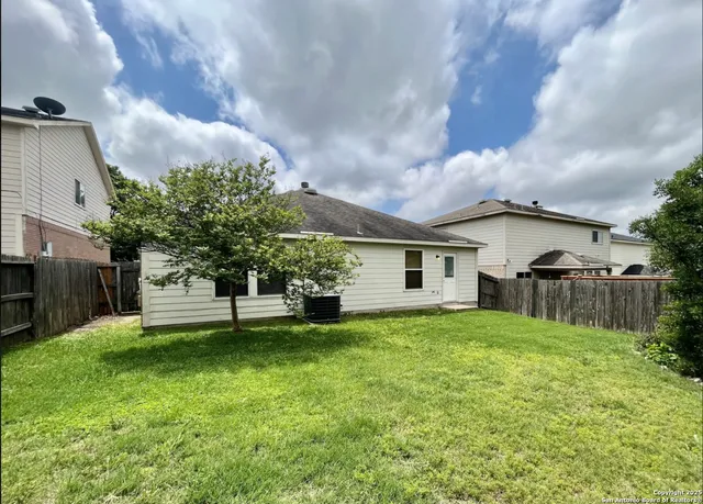 a house view with a sitting space and garden