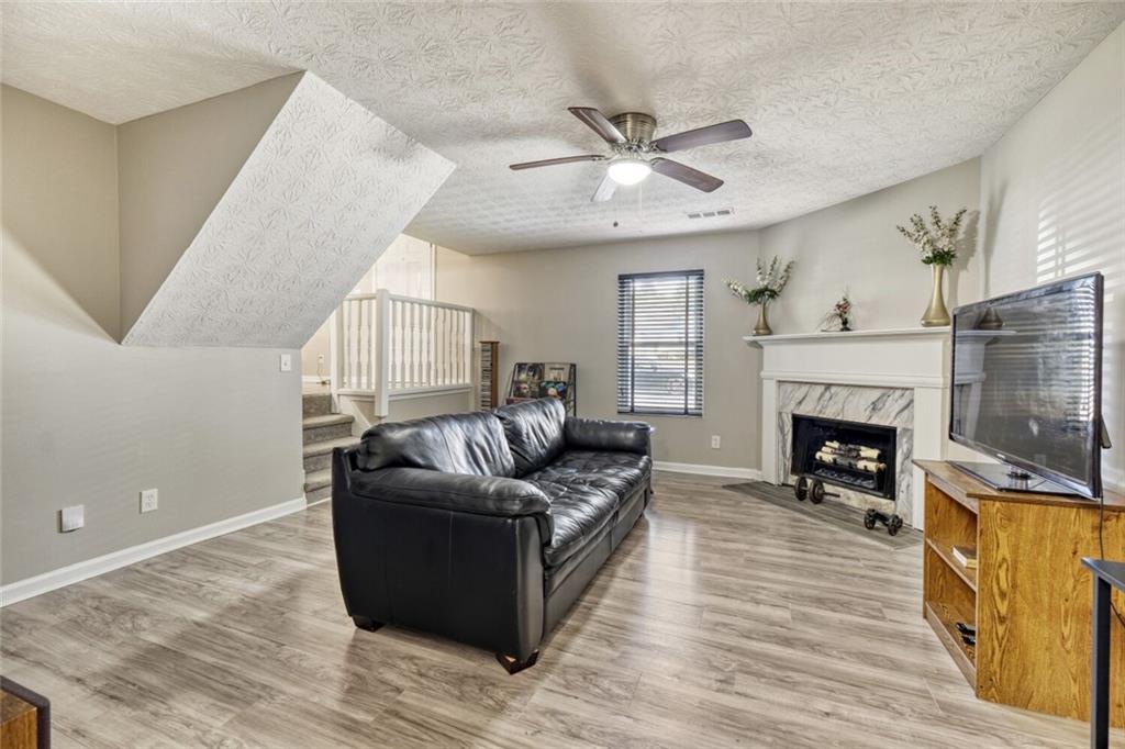 5544 Alpine Court Lithonia, GA 30038 - Photo 12 of 28 a living room with furniture and a fireplace
