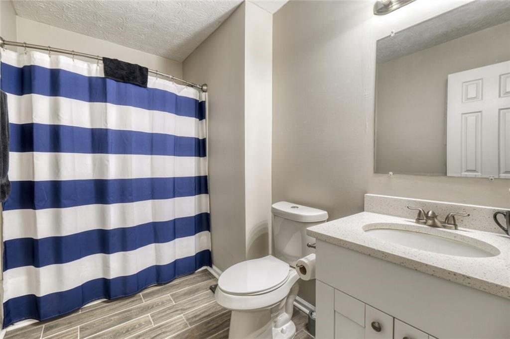 5544 Alpine Court Lithonia, GA 30038 - Photo 15 of 28 a bathroom with a sink and a toilet