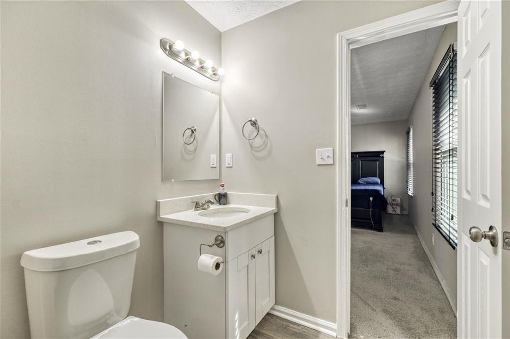5544 Alpine Court Lithonia, GA 30038 - Photo 16 of 28 a bathroom with a sink a toilet and a mirror