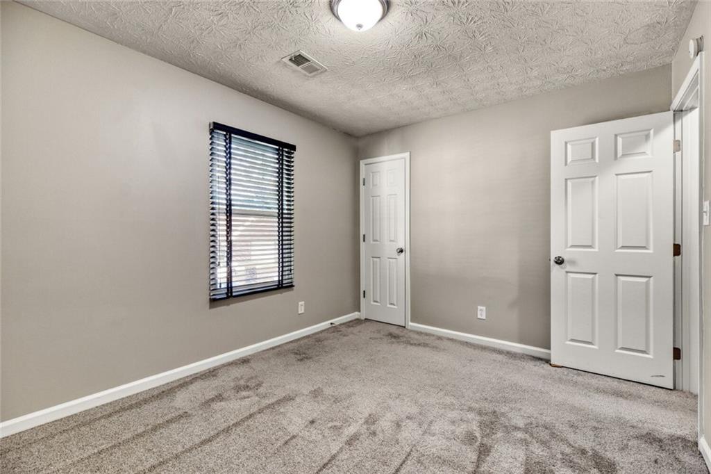 5544 Alpine Court Lithonia, GA 30038 - Photo 17 of 28 a view of an empty room with a window