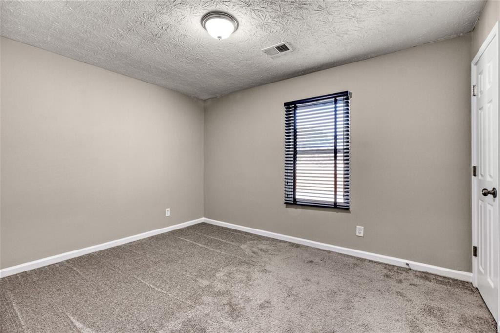 5544 Alpine Court Lithonia, GA 30038 - Photo 18 of 28 an empty room with a window