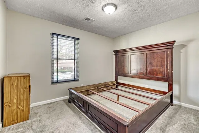 a living room with a bed and a window