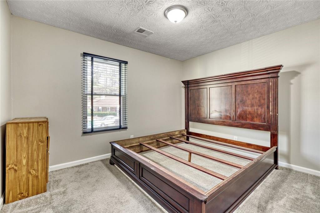 5544 Alpine Court Lithonia, GA 30038 - Photo 19 of 28 a living room with a bed and a window
