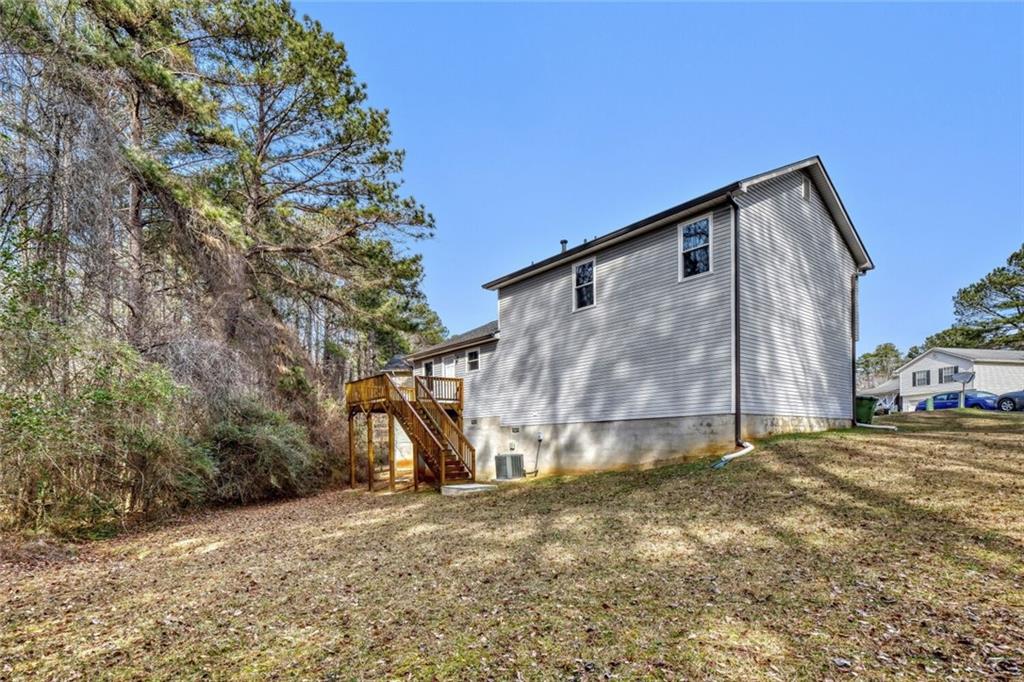 5544 Alpine Court Lithonia, GA 30038 - Photo 27 of 28 a house with trees in the background