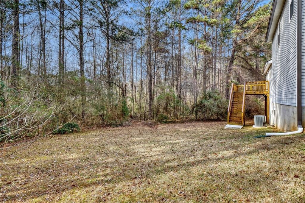 5544 Alpine Court Lithonia, GA 30038 - Photo 28 of 28 a view of a yard with trees