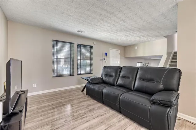 a living room with furniture window and a flat screen tv