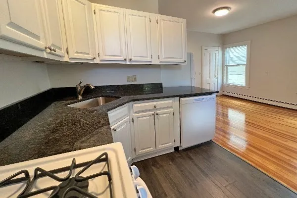 a kitchen with granite countertop wooden cabinets and a granite counter tops