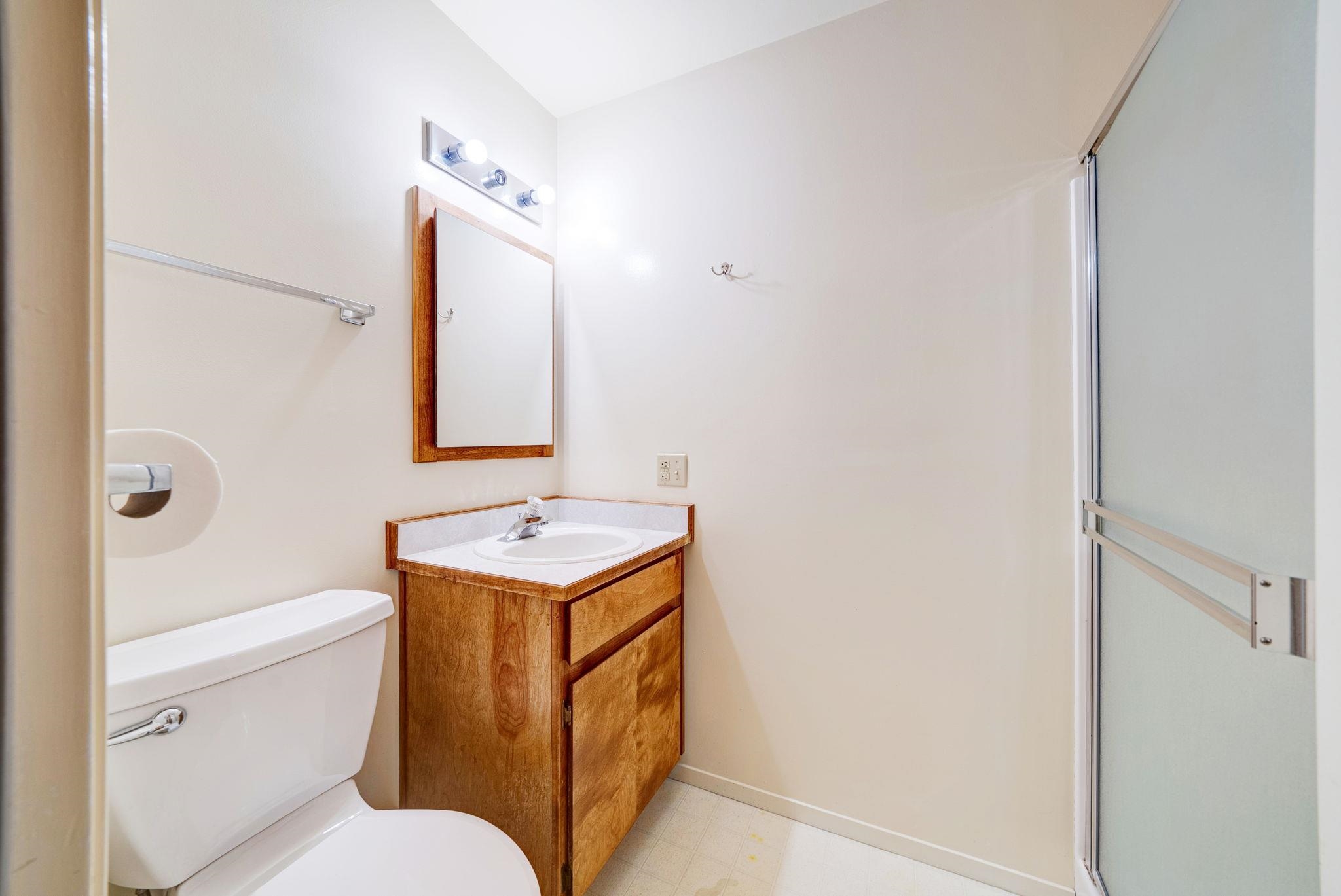 485 Ridge Street Portola, CA 96122 - Photo 14 of 27 a bathroom with a sink toilet vanity mirror and shower