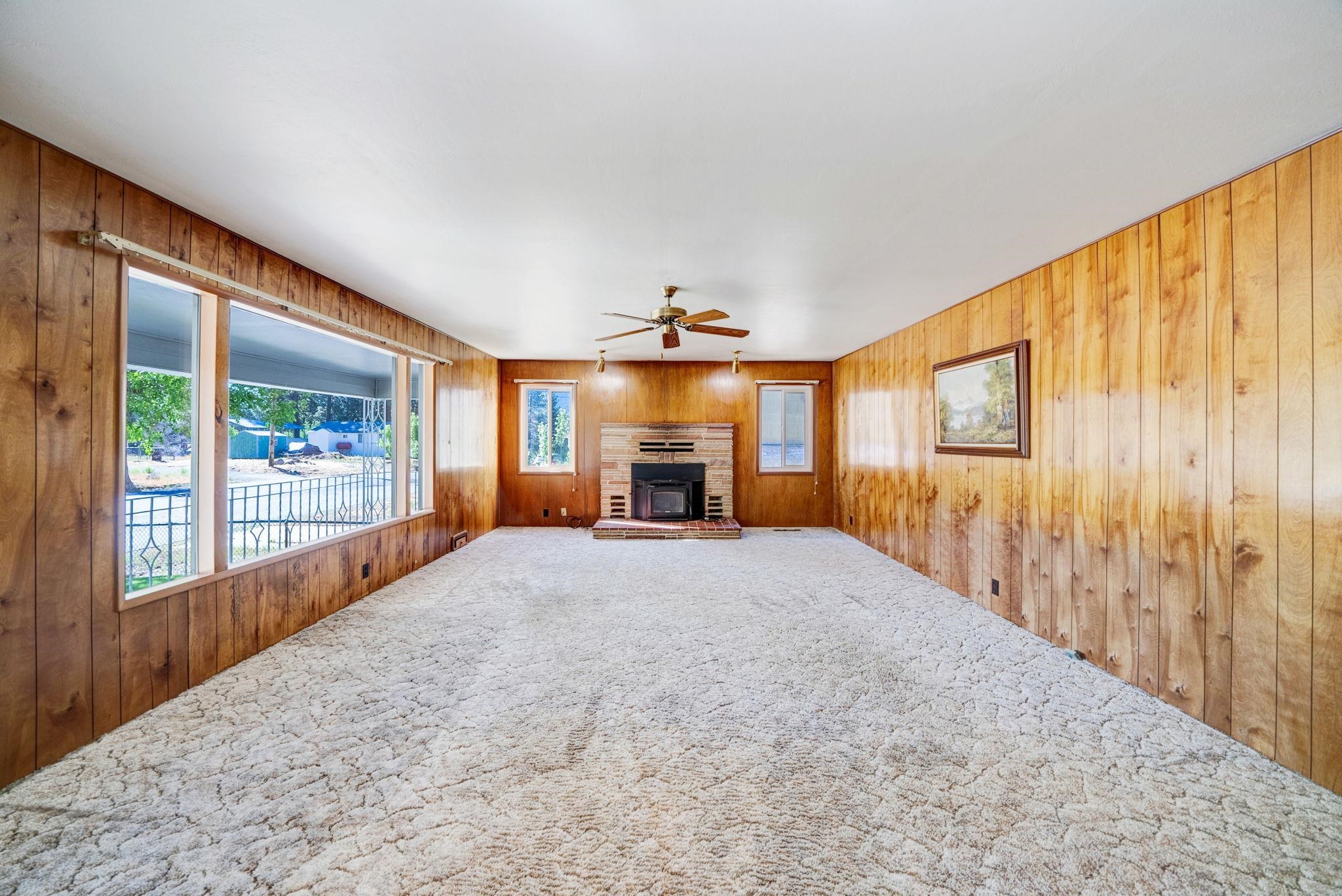 485 Ridge Street Portola, CA 96122 - Photo 4 of 27 a big room with wooden floor fireplace and windows