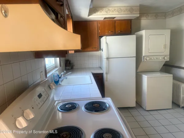 a kitchen with a refrigerator and a stove