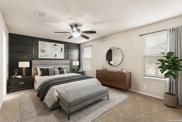 a bedroom with a bed a chandelier and dresser