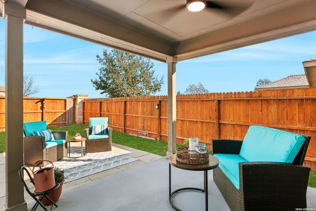 a view of a chairs and table in patio