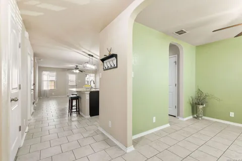 a view of a hallway with wooden shelves