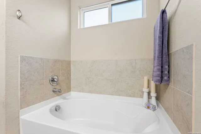 a white bath tub sitting in a bathroom