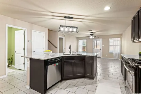 a kitchen with a sink and a stove top oven