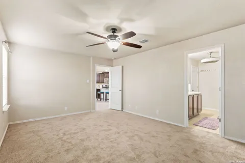 an empty room with closet and a ceiling fan