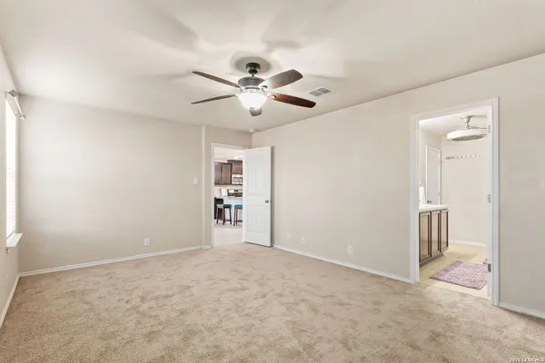 an empty room with closet and a ceiling fan