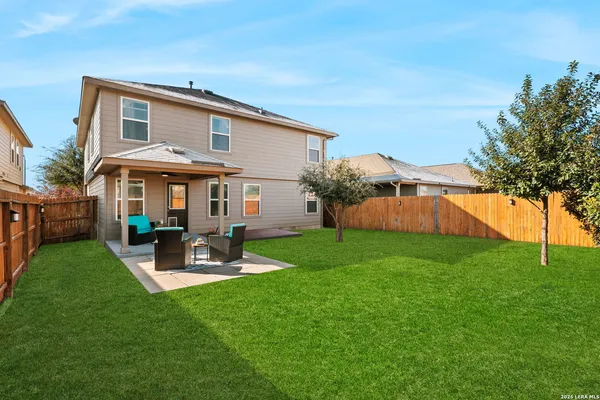 a front view of a house with garden and patio