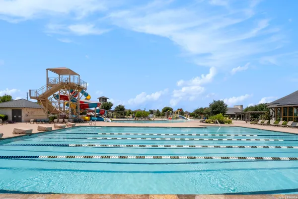 a view of a swimming pool with a yard