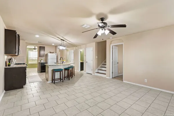 a view of kitchen with furniture and a chandelier