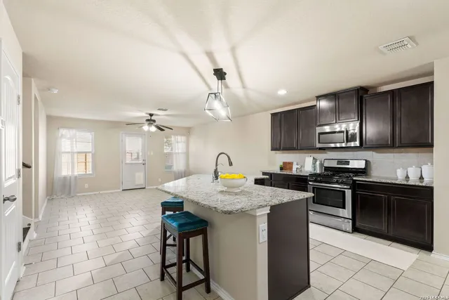 a kitchen with stainless steel appliances granite countertop a stove a sink dishwasher a microwave oven with granite countertops and cabinets